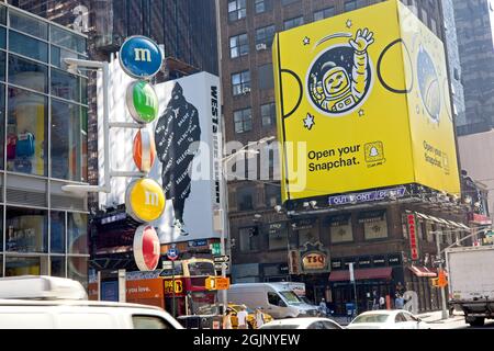 New York, NY, USA - Sept 10, 2021: Competing signs and billboards above the traffic at Times Square Stock Photo