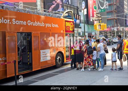 New York, NY, USA - Sept 10, 2021: People waiting to enter a tour bus in the Times Square area Stock Photo
