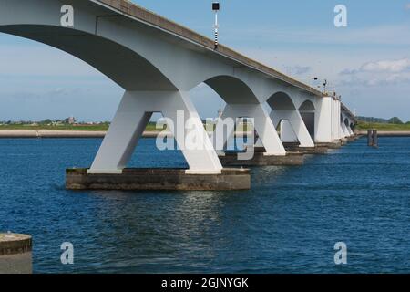 View on longest bridge in the Netherlands, Zealand bridge spans Eastern Scheldt estuary, connects islands of Schouwen-Duiveland and Noord-Beveland in Stock Photo