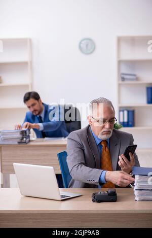 Two colleagues working at workplace Stock Photo
