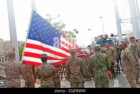 Ambouli, Djibouti. 11th Sep, 2021. U.S. and coalition military service members raise an American flag during a remembrance event on the 20th anniversary of the 9/11 terrorist attacks at Camp Lemonnier September 11, 2021 in Ambouli, Djibouti. The event commemorates the nearly 3,000 people killed by terrorists on September 11th, 2001. Credit: MC1 Jacob Sippel/U.S. Navy/Alamy Live News Stock Photo