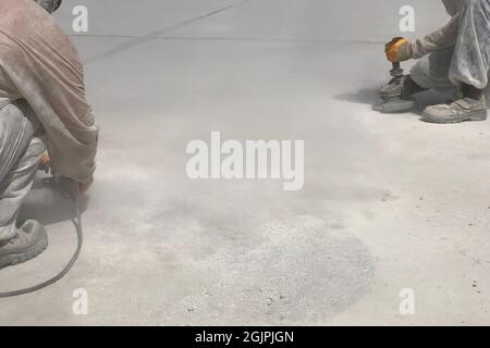 Construction workers are grinding concrete surface Stock Photo
