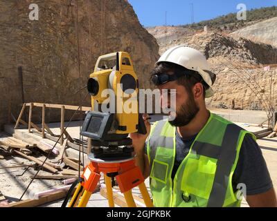 Land surveyor works at construction site Stock Photo