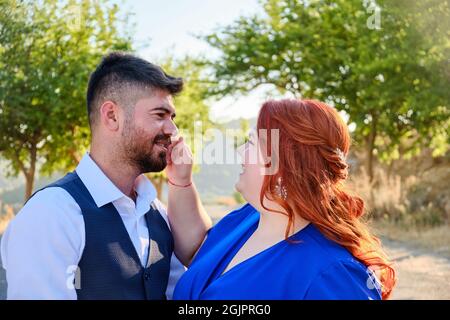 Woman touches man smiling Stock Photo