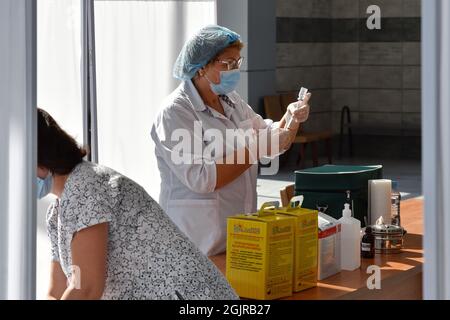 Kramatorsk, Ukraine. 11th Sep, 2021. A medical worker prepares to administer the a Covid-19 vaccine at a vaccination centre inside the city's bus station in Kramatorsk.From September 13, a yellow level of epidemic threat may be introduced across Ukraine due to the growing COVID-19 incidence. This was stated by Health Minister Viktor Liashko. As for the red quarantine zone, it will be introduced in several regions, where the rates of morbidity and hospitalization exceed the normal ones. Credit: SOPA Images Limited/Alamy Live News Stock Photo