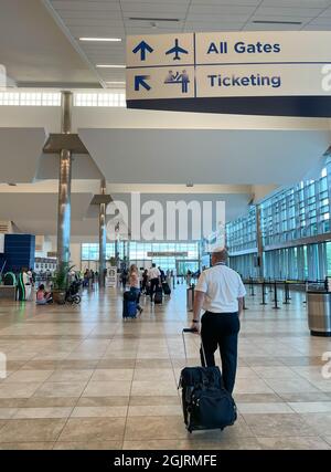 Myrtle Beach, SC USA - September 3, 2021: Interior view of the Myrtle Beach International Airport with flight attendants and customers passing by Stock Photo