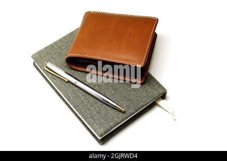 Notebook with pen and brown leather wallet isolated on white background Stock Photo