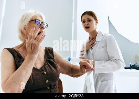 emotional elderly woman big syringe vaccine passport Stock Photo