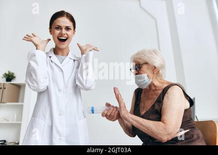 emotional elderly woman syringe injection fun Stock Photo