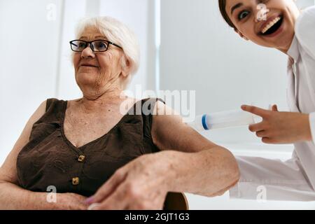 emotional elderly woman big syringe immunity protection Stock Photo