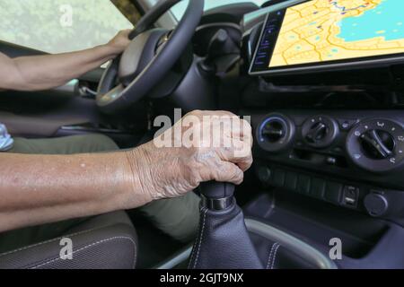 Elderly woman using GPS navigation system in car Stock Photo
