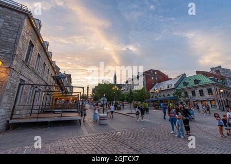 Montreal, Quebec, Canada - August 25 2021 : Old Montreal district street view at dusk. A steady stream of tourists come to visit here during covid-19 Stock Photo