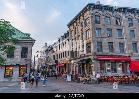 Montreal, Quebec, Canada - August 25 2021 : Old Montreal district street view at dusk. A steady stream of tourists come to visit here during covid-19 Stock Photo