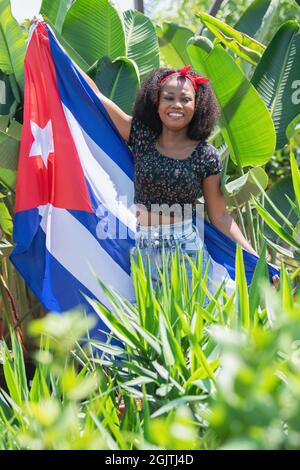 Vertical photo of an afro woman with a Cuban flag Stock Photo
