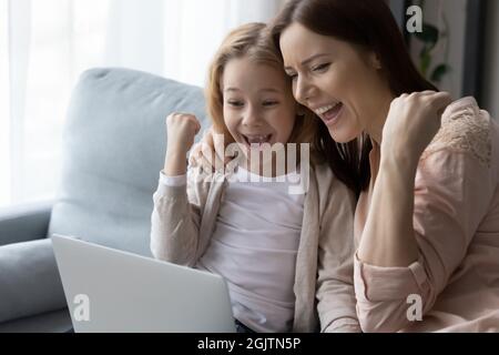 Cheerful family celebrating getting amazing news at home. Stock Photo