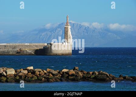 View of the harbour wall and entrance with views to the Moroccan coastline and Rif mountains, Tarifa, Cadiz Province, Andalusia, Spain, Europe. Stock Photo
