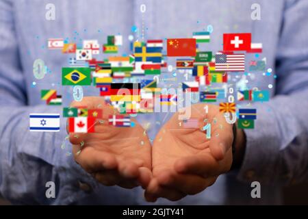 A person presenting the virtual projection of international country flags with binary codes Stock Photo