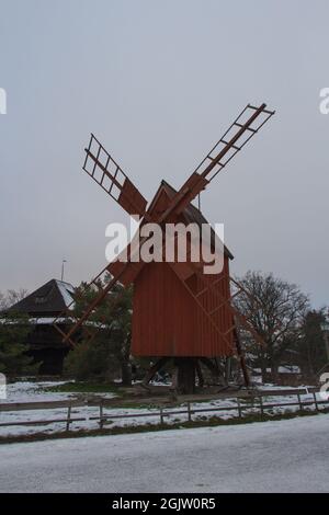 Stockholm, Sweden - December 29 04 2018: exterior view of wooden wind mill painted in traditional falun red in Skansen Open-Air Museum on December 29 Stock Photo