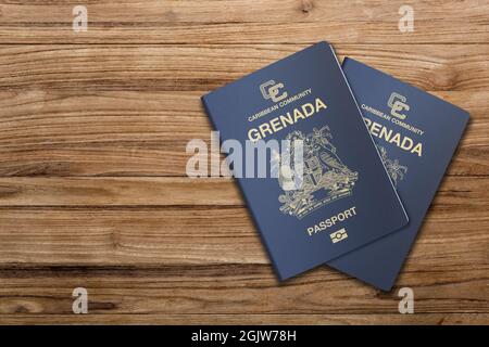Grenada passport on a wooden background, for citizens of the state of Grenada Stock Photo