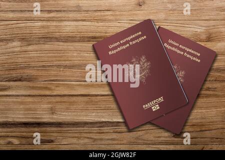 Two French passports on dark wooden board Stock Photo