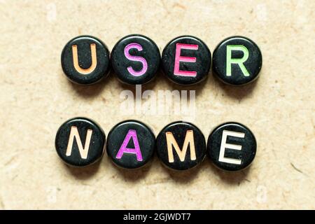Black color round alphabet letter block in word user name on wood background Stock Photo