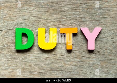 Color alphabet letter in word duty on wood background Stock Photo