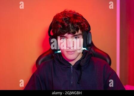 Young man in headset in neon illumination Stock Photo