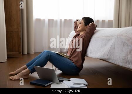 Young indian lady working at home make pause to relax Stock Photo