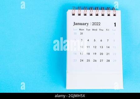 January 2022 desk calendar on blue background. Stock Photo