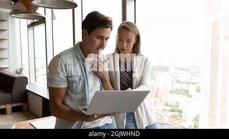 Diverse employees use computer discuss financial project online Stock Photo