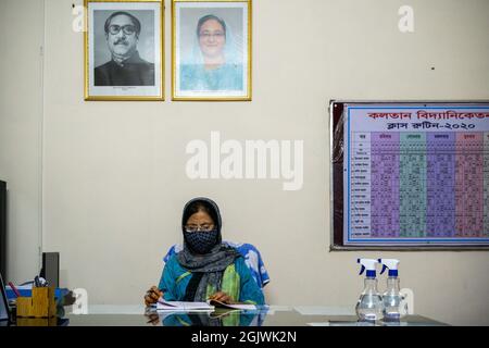 Non Exclusive: DHAKA, BANGLADESH - SEPTEMBER 11: The principal of Kolotan Bidyaniketon is seen working on the evening in his office room during the re Stock Photo