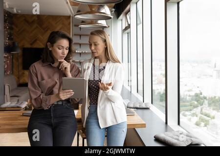 Female employees use tablet discuss online project Stock Photo