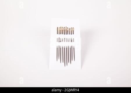 Set of steel sewing needles of various sizes for sewing, isolated on white background Stock Photo