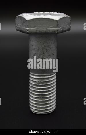 Galvanized steel metal with metric bolt, isolated on black background Stock Photo