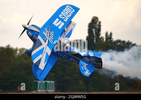 Rich Goodwin demonstrated his skills flying his blue Pitts Special biplane G-JPIT in a knife-edge pass at the Abingdon Air & Country Show 2021 Stock Photo