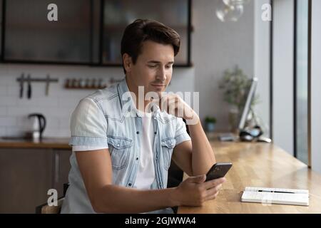 Young Caucasian man use cellphone browsing internet Stock Photo