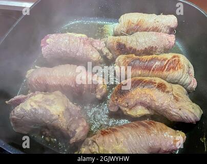 fry fresh roulades in the pan Stock Photo