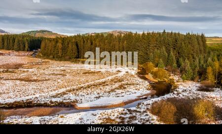 Sun shining over a snow covered Big Water of Fleet at the Cairnsmore of Fleet National Nature Reserve, Dumfries and Galloway, Scotland Stock Photo