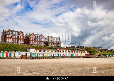 14 June 2019: Lowestoft, Suffolk, England - Beach huts and apartment blocks at South Beach, Lowestoft Stock Photo