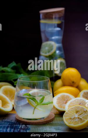 Refreshing summer cocktail with lemon and lime, mint lemonade in a glass and bottle.Mojito cocktail, Stock Photo