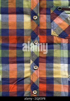 Multi colored classic plaid fabric, shirt pocket and button detail, checked shirt detail Stock Photo