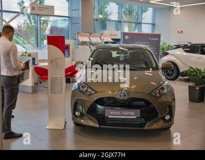 KYIV, UKRAINE - MAY 15, 2021: New Toyota Yaris Hybrid car on display in car dealership City Plaza. It is a supermini subcompact car sold by Toyota sin Stock Photo