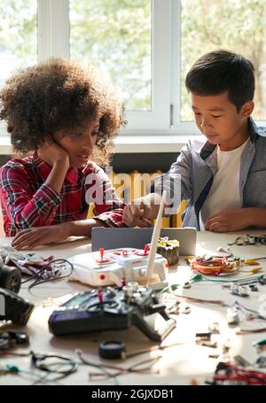 Group of multiracial schoolkids in classroom. STEM education concept. Stock Photo
