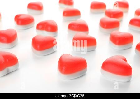 Heart-shaped jelly candies on white background