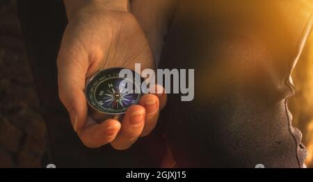 Traveler using compass in the woods, stock photo Stock Photo