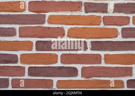 Rough old porous bricks with white grout. Texture surface wall background Stock Photo