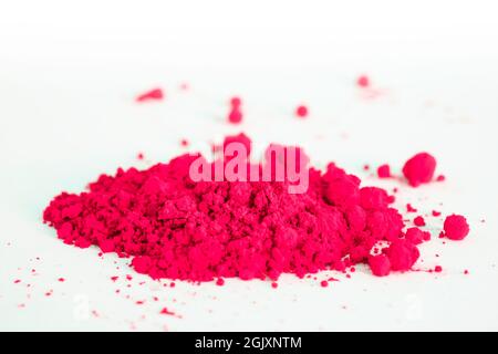 Close up of a portion of red pigment isolated on white. The pigment can be used as a base for makeup or mixed with linseed oil to make oil paint Stock Photo