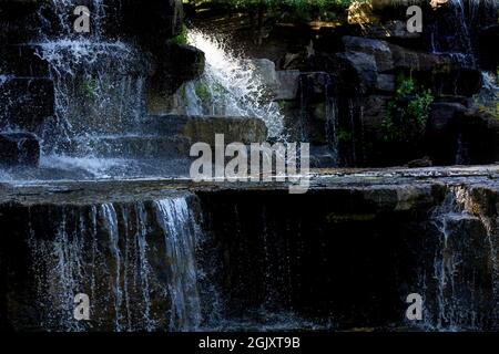 The beautiful artificial waterfall in the state park Stock Photo