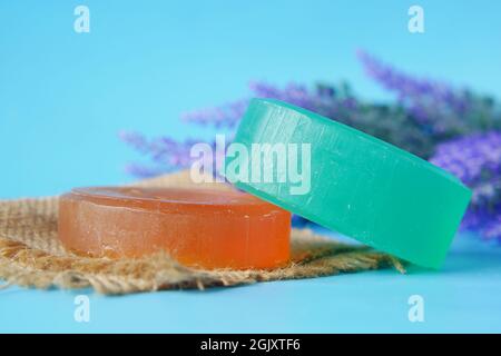 Homemade soap with dried lavender on blue background with copy space  Stock Photo