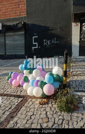 colorful balloons with an abandoned and dirty property in the background in northern Brazil Stock Photo